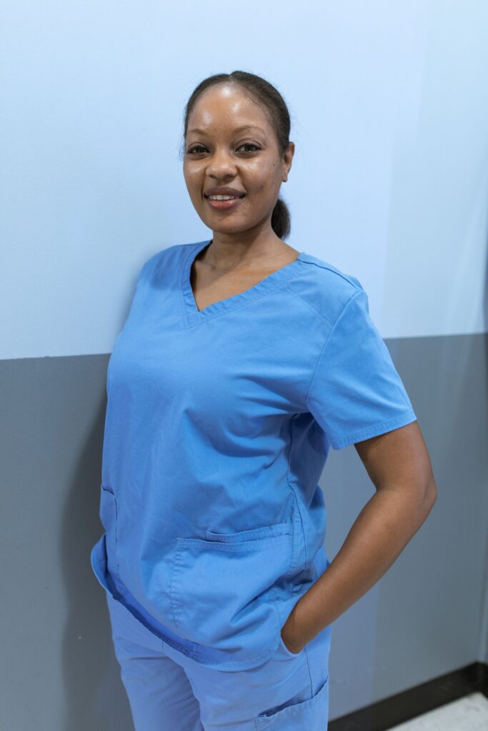 Smiling carer in blue scrubs